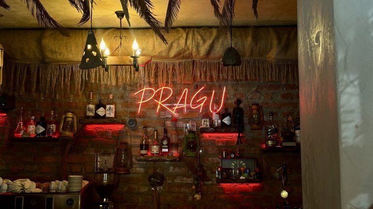 photo of Pragu Neon sign inside the door