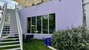 Photo of the front of the building, purple square box building outside of the Pyramid of Tirana