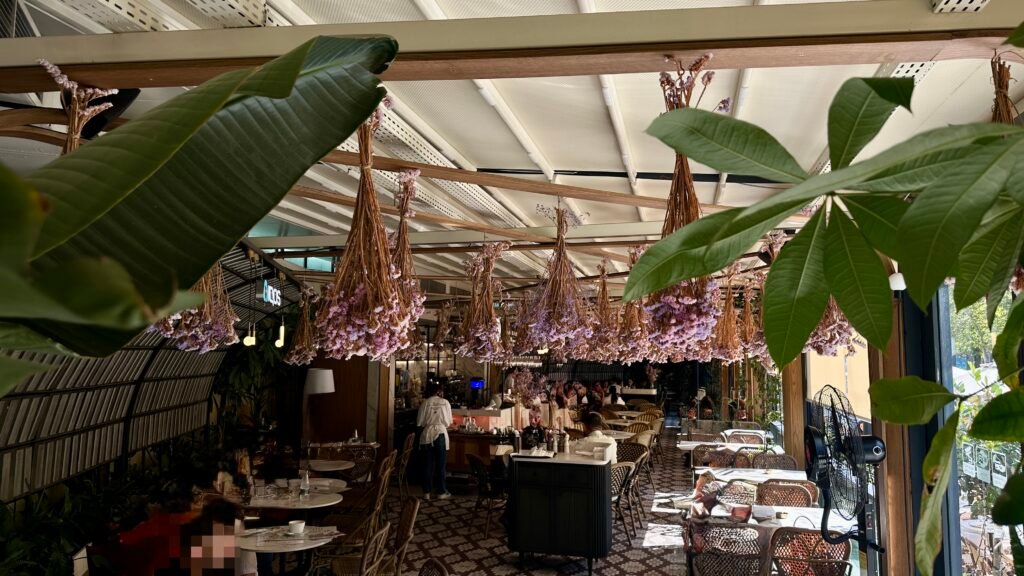 Photo of the exterior with flowers hanging from the ceiling
