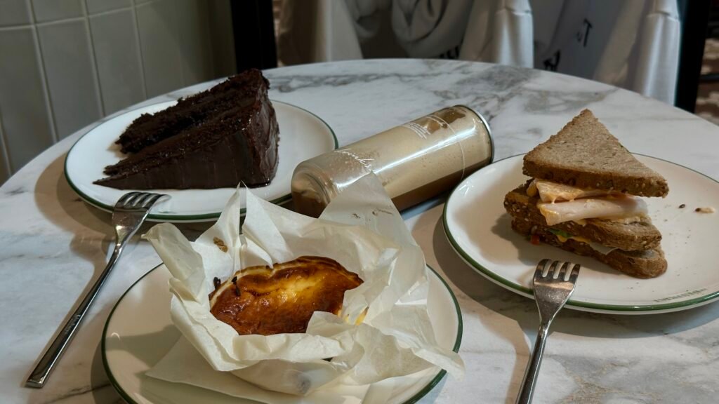 Photo of cheesecake, turkey sandwich, and chocolate cake at Le District.